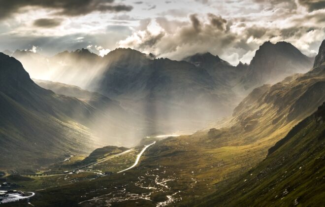 green mountains under white clouds