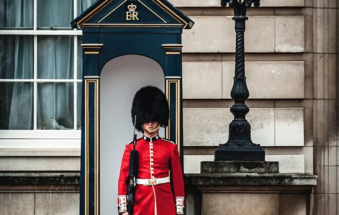 royal guard standing near lamp post