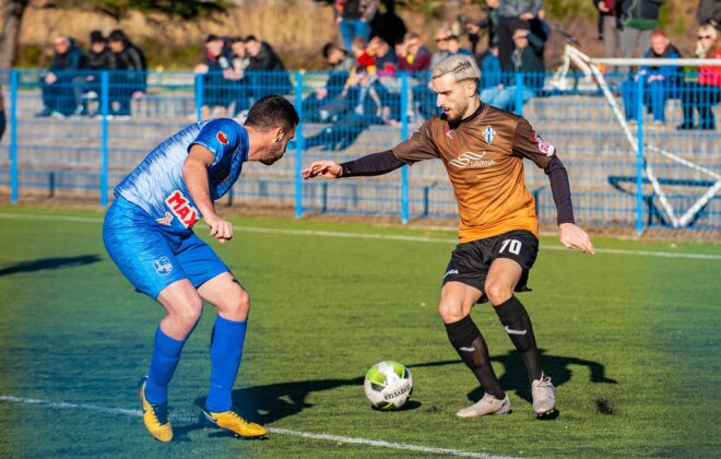 photo of man playing soccer during daytime